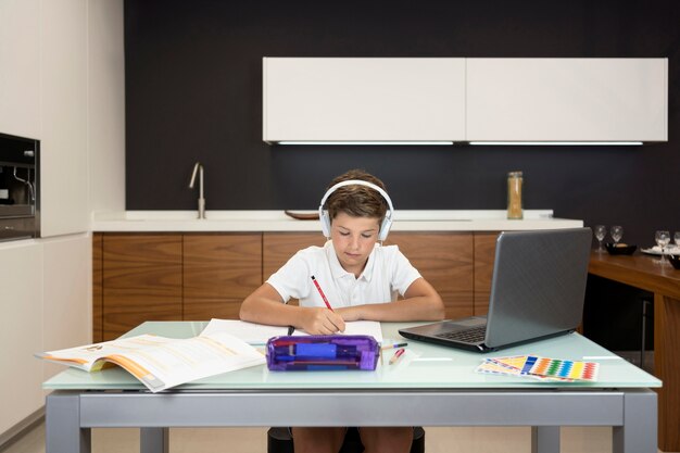 adorable-young-boy-doing-his-homework_23-2148622790